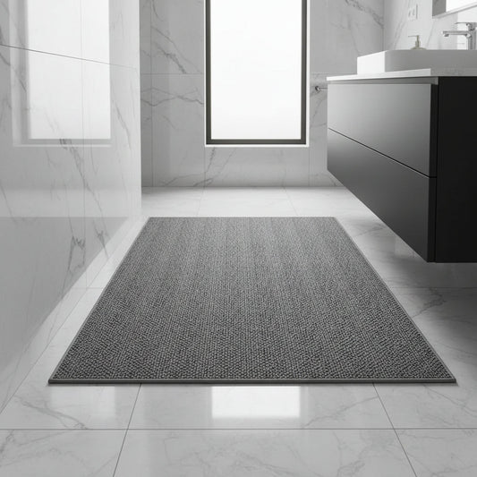 Dark grey looped-pile mat with a matching bound edge on white marble bathroom tiles 1