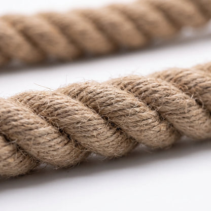 Close-up of the twisted strands of the rope, showing the rough, fibrous texture of the natural material against a white surface. 3