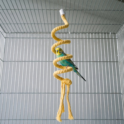 Budgerigar with a yellow head and turquoise body perching on the yellow spiral rope inside a wire cage. 2