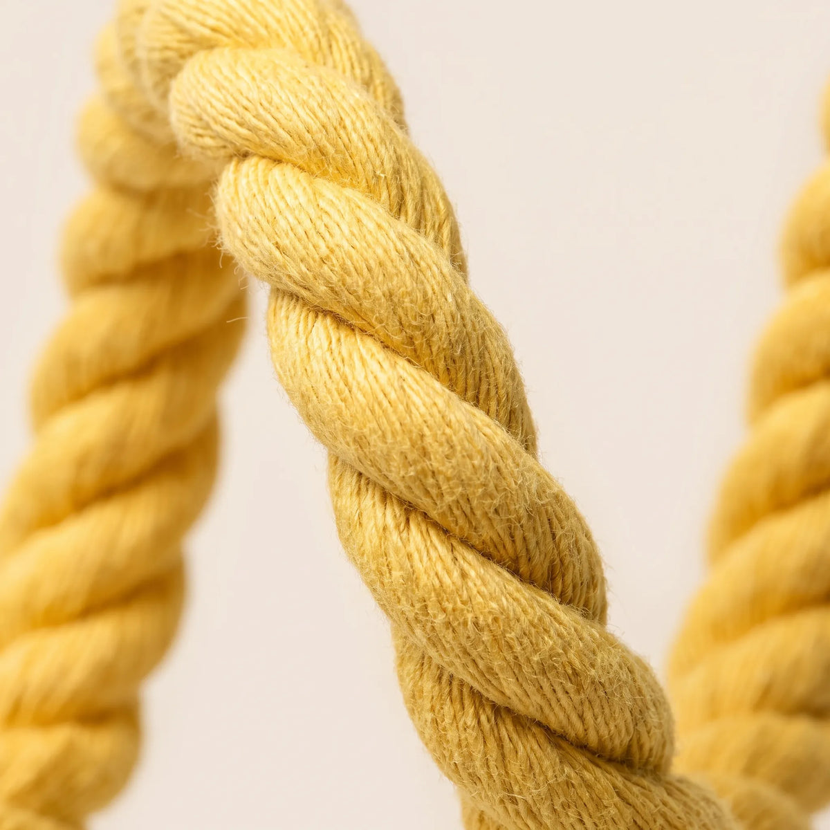 Close-up of the twisted yellow rope showing the thick, fibrous strands and soft, slightly fuzzy texture. 3