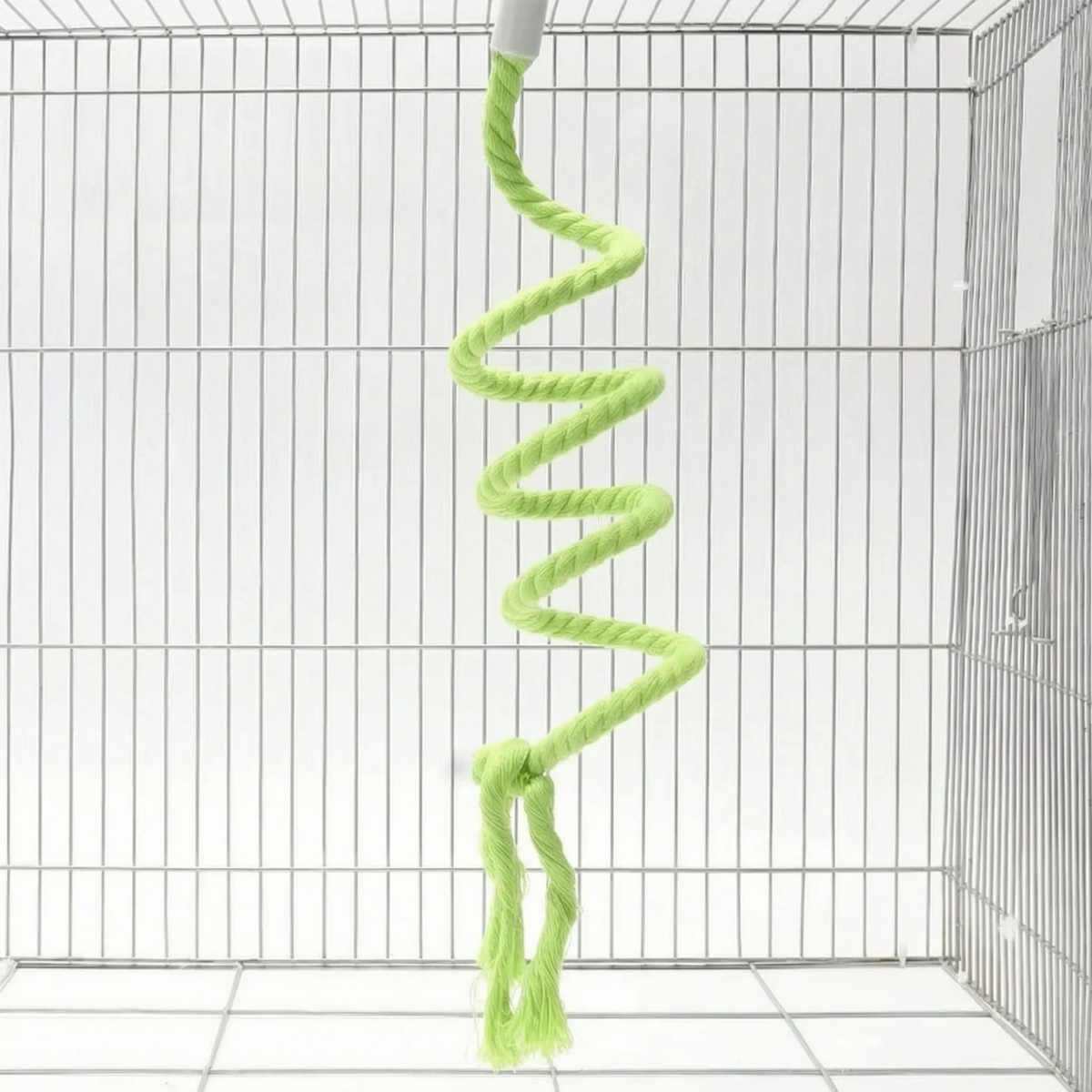Green version of the spiral rope perch hanging in a white wire cage, with a knot and two frayed tails. 5