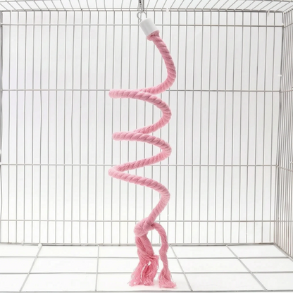 Pink version of the spiral rope perch hanging from a small hook in a white wire cage, with a knotted, frayed end. 6