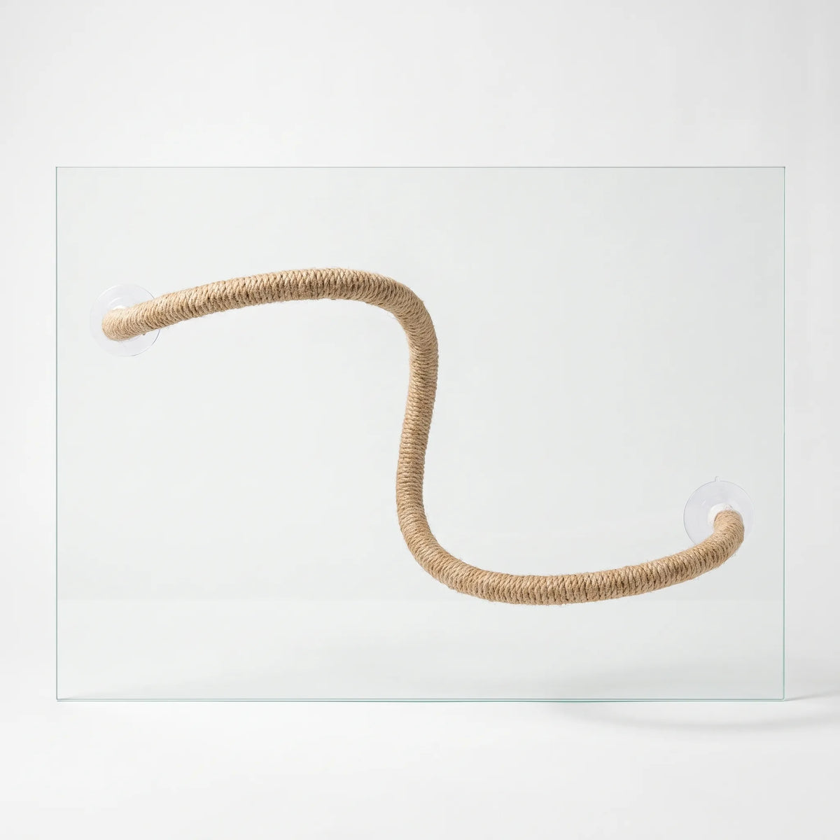 Twisted natural-fibre rope perch bent into an S shape, held by two clear suction cups on a glass pane against a plain backdrop. 1