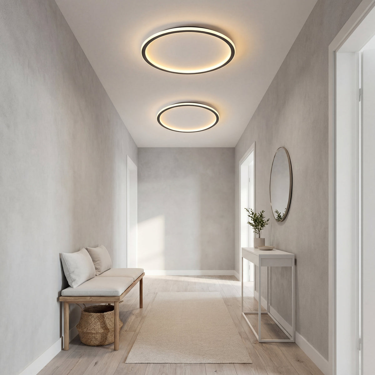 Two ring lights of different sizes lit along a narrow entrance hall with a bench, console table and round mirror. 6