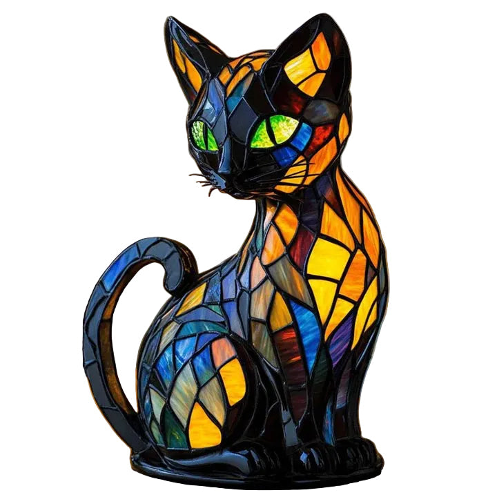 Seated black cat figure made of colourful mosaic panels in amber, blue and red, with green eyes, on white 1