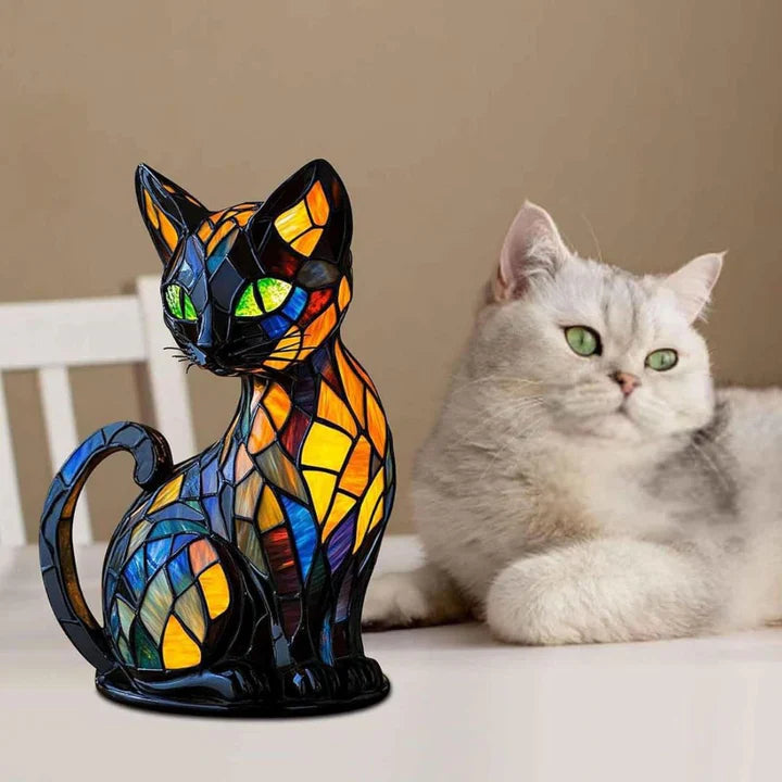 Cat lamp on a white surface next to a real grey and white cat with green eyes 4