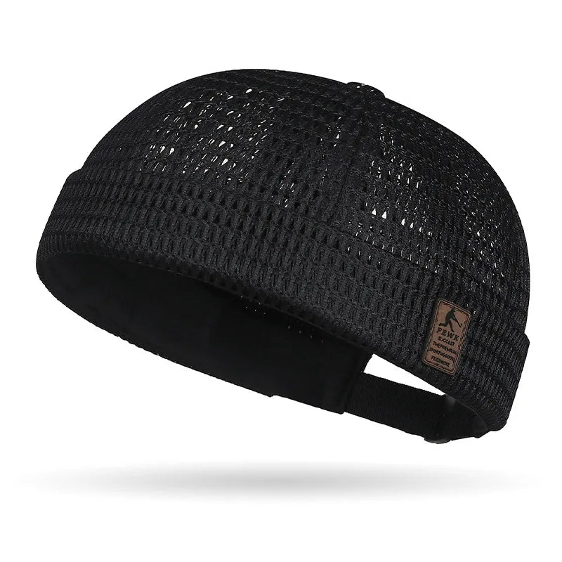 Black open weave cap with leather-look patch and back strap, seen from the side 18