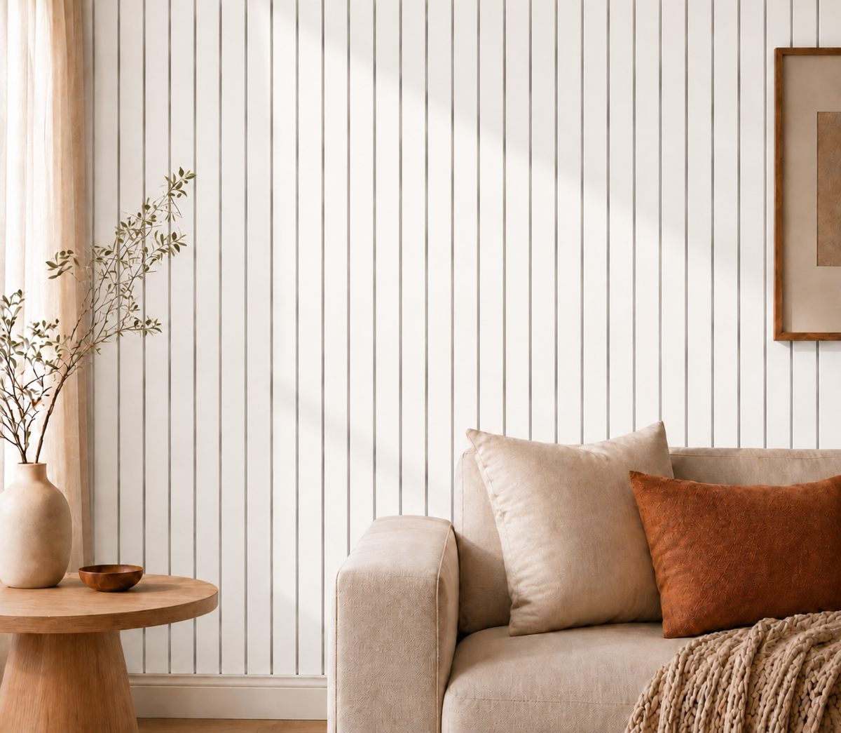 White vertical slat wall behind a beige sofa, round wooden side table and vase 21