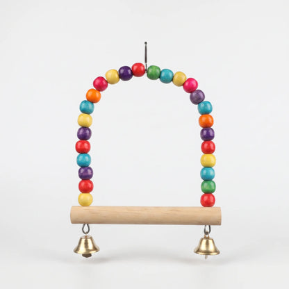 Swing hanging against a white background, showing the bead arch, round wooden perch, metal hook and two small bells. 5