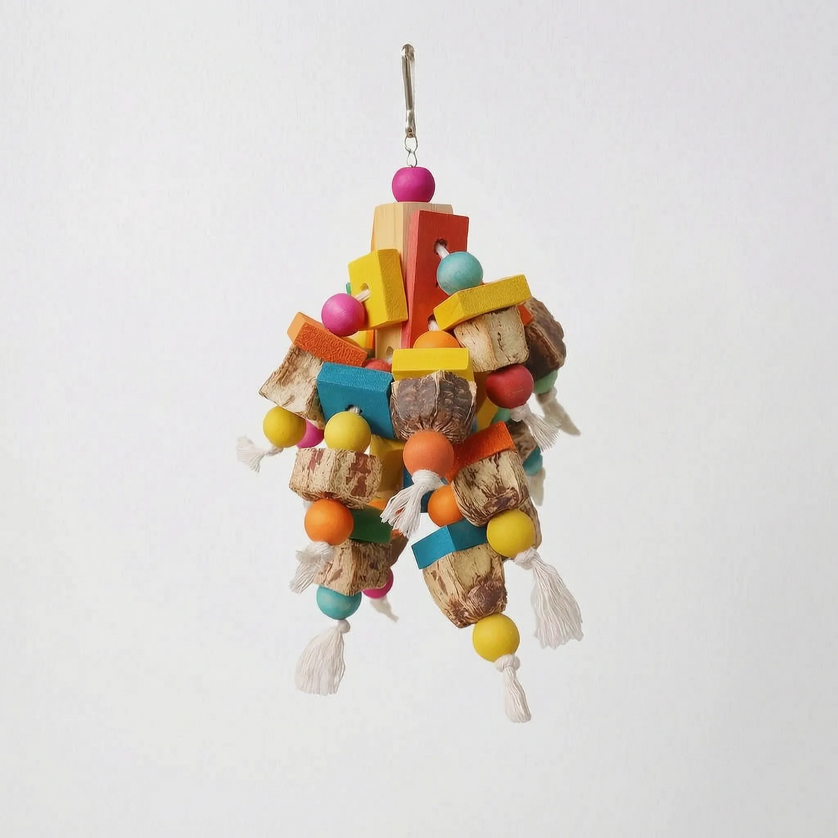 A different, chunkier toy design with flat coloured wooden slats, round beads, natural nut-shell pieces and rope tassels on a plain background. 5
