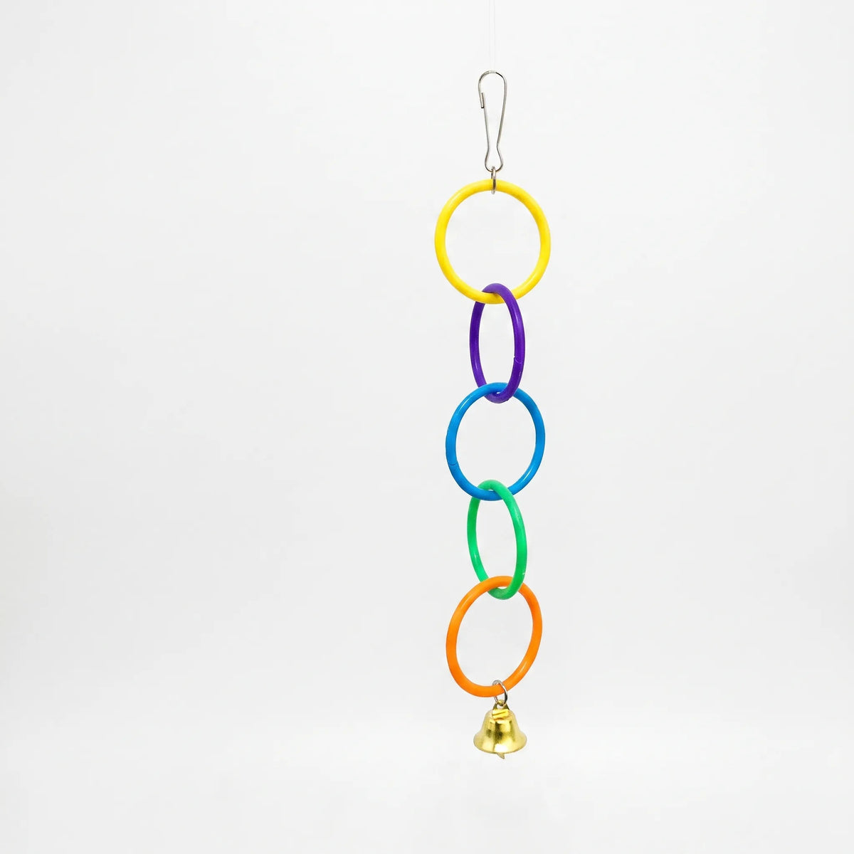 Chain of five linked plastic rings in yellow, purple, blue, green and orange with a small gold bell, on a plain white background. 1