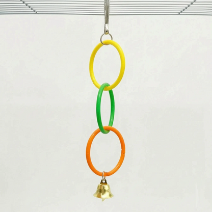 Shorter version of the toy with only three linked rings, yellow, green and orange, and a gold bell, hanging from a cage roof. 5