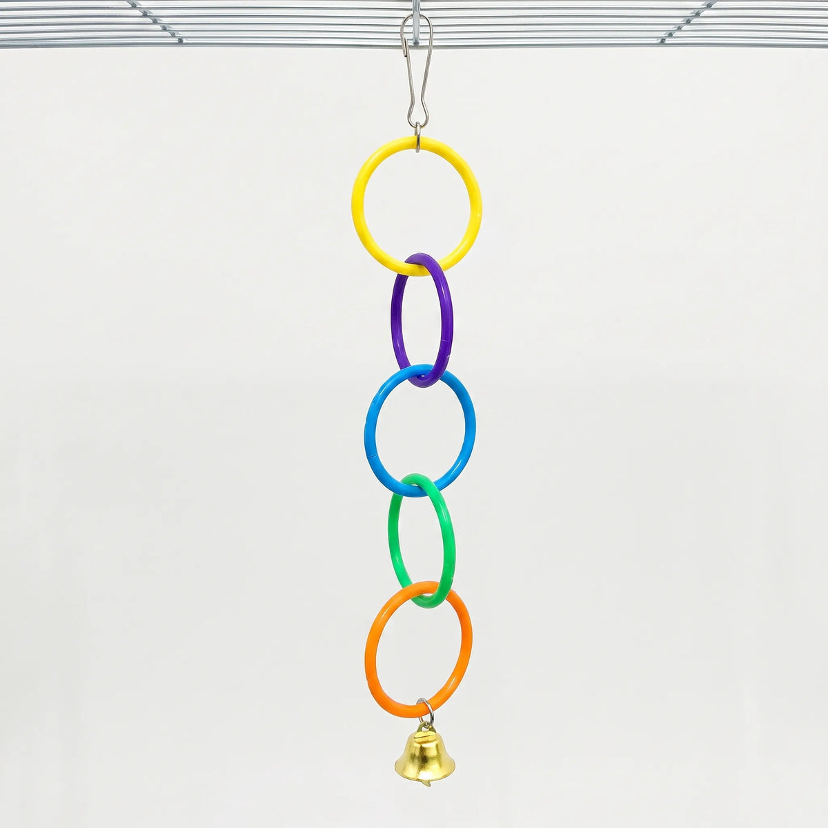 Full five-ring chain in yellow, purple, blue, green and orange, with a gold bell, hanging from a wire cage roof against a pale background. 6
