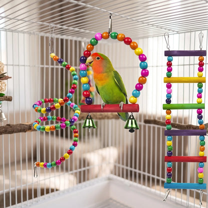 Green and orange lovebird on the bead arch swing, with the bead spiral and rainbow ladder hanging beside it in the cage. 3