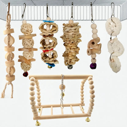 Natural wood alternative set hung from a cage roof: rattan balls, woven chew toys, loofah pieces, bells and a beaded swing. 6