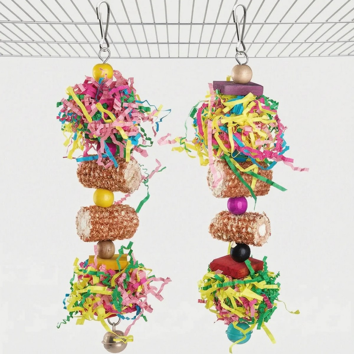 Two hanging toys made of shredded coloured paper, loofah-style rolls, wooden beads and blocks, each with a small bell. 5