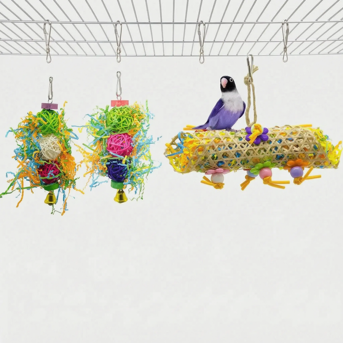 Shredded-paper toys with woven rattan balls and bells, plus a woven cane tube with a lovebird standing on top. 6