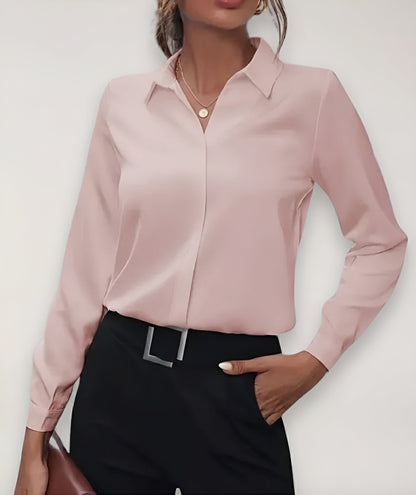 Pale pink blouse worn by a model with black trousers, one hand in pocket 2
