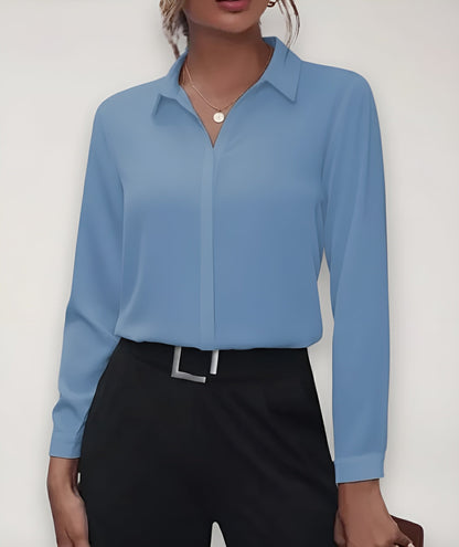 Dusty blue blouse worn by a model with black trousers and a square-buckle belt 3