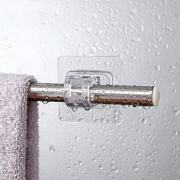 Clear adhesive clip holding a metal rod with a lilac towel on a wall covered in water droplets. 4