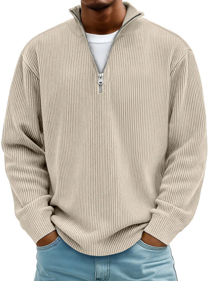 Man wearing the half-zip ribbed jumper in beige over a white tee, hands in jeans pockets 4