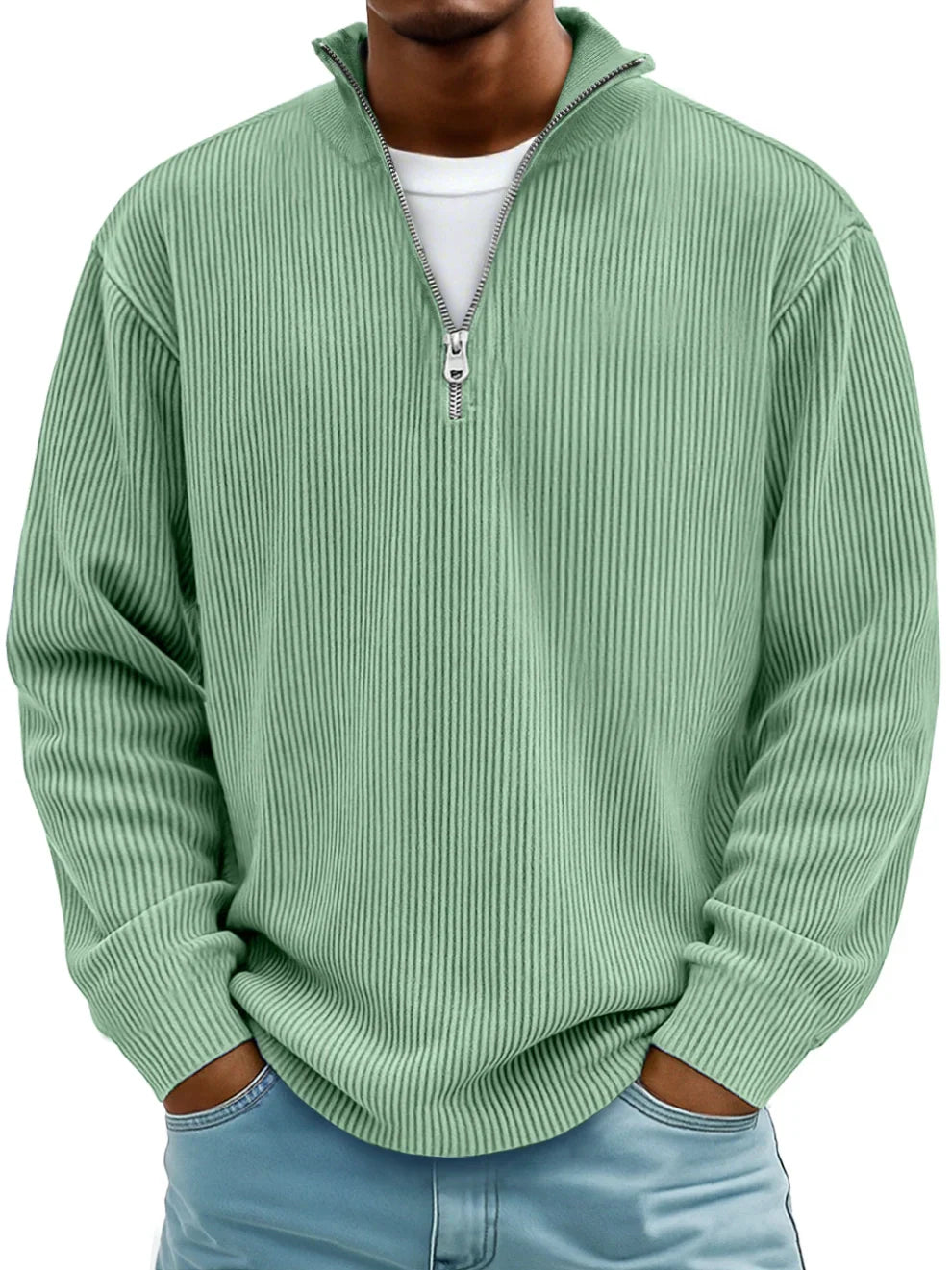 Man wearing the half-zip ribbed jumper in mint green over a white tee, hands in jeans pockets 3