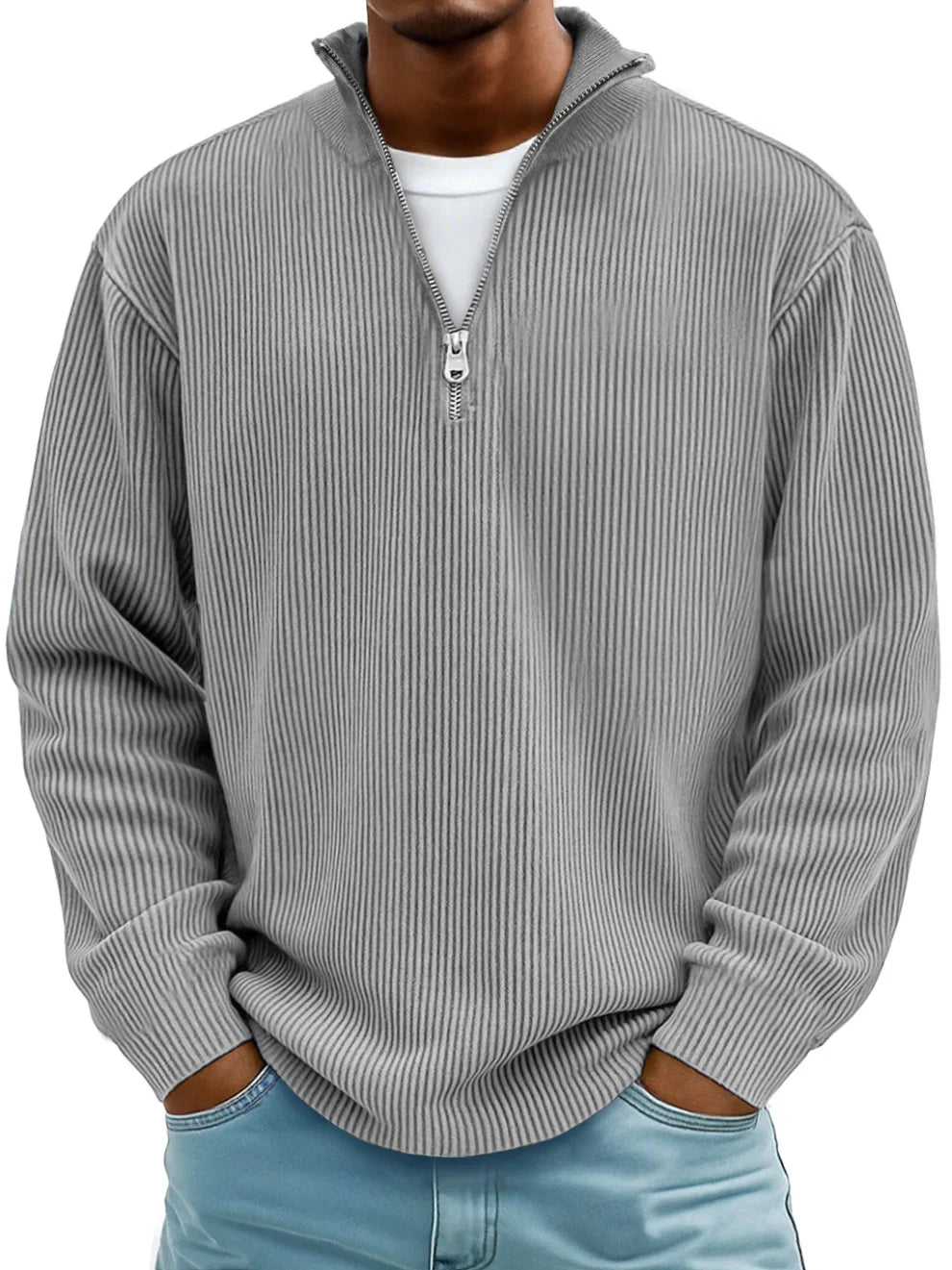 Man wearing the half-zip ribbed jumper in grey over a white tee, hands in jeans pockets 2
