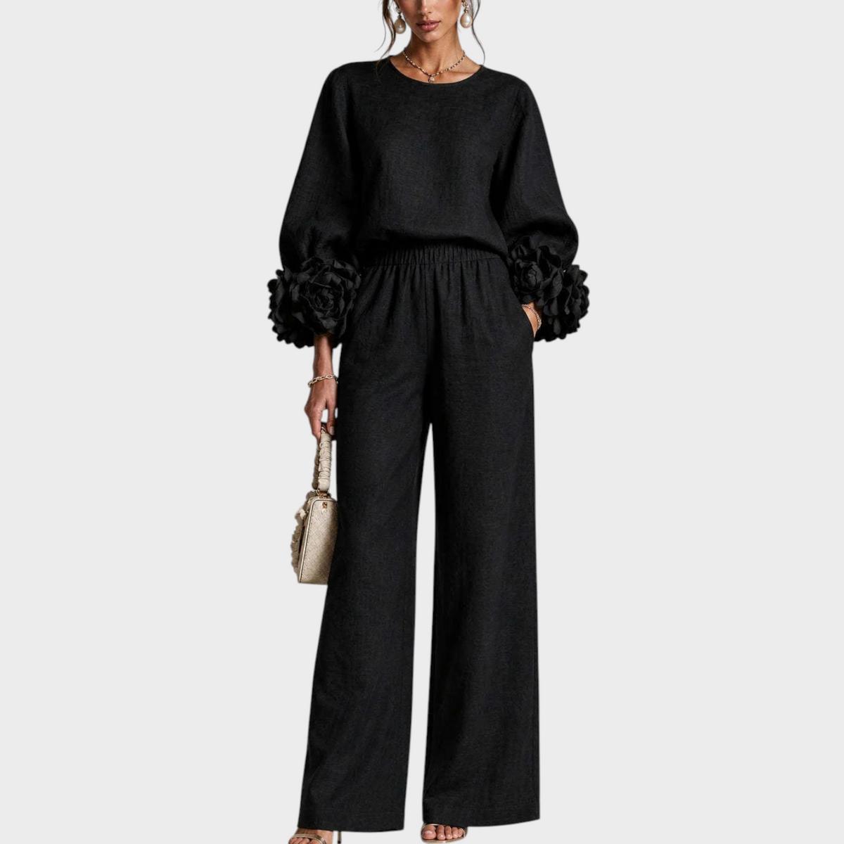 Model in the black set, front view, showing the rose-trimmed sleeves and high elasticated waist 3