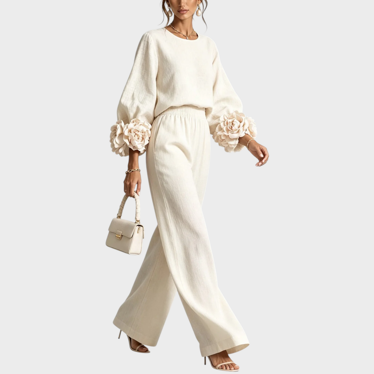 Model walking in the cream set, showing the flowing wide-leg trousers and flower cuffs 5