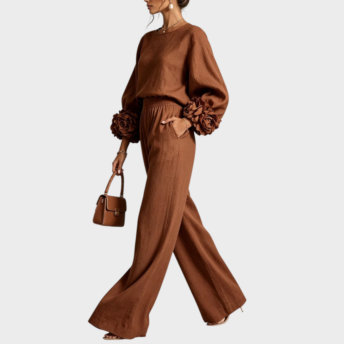 Model in the rust brown set seen from the side, striding with a matching handbag 6