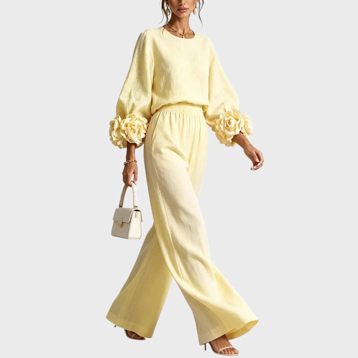 Model walking in the pale yellow set, with large fabric roses on the sleeve cuffs 7
