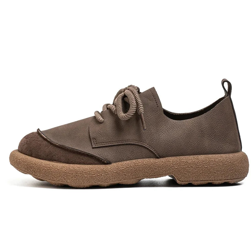 Side profile of a single brown lace-up shoe with a chunky tan sole on white 7