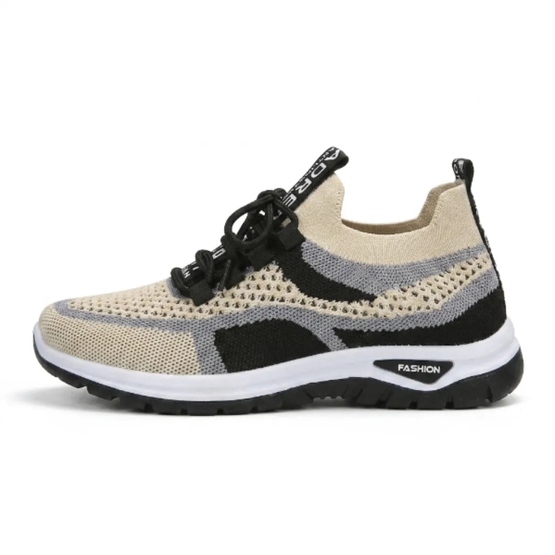 Side view of a single beige, grey and black mesh trainer with black laces and a white and black sole. 37