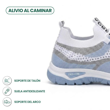 Rear three-quarter view of the pale blue trainer showing the heel and sole, with icons for heel support and anti-slip sole. 4