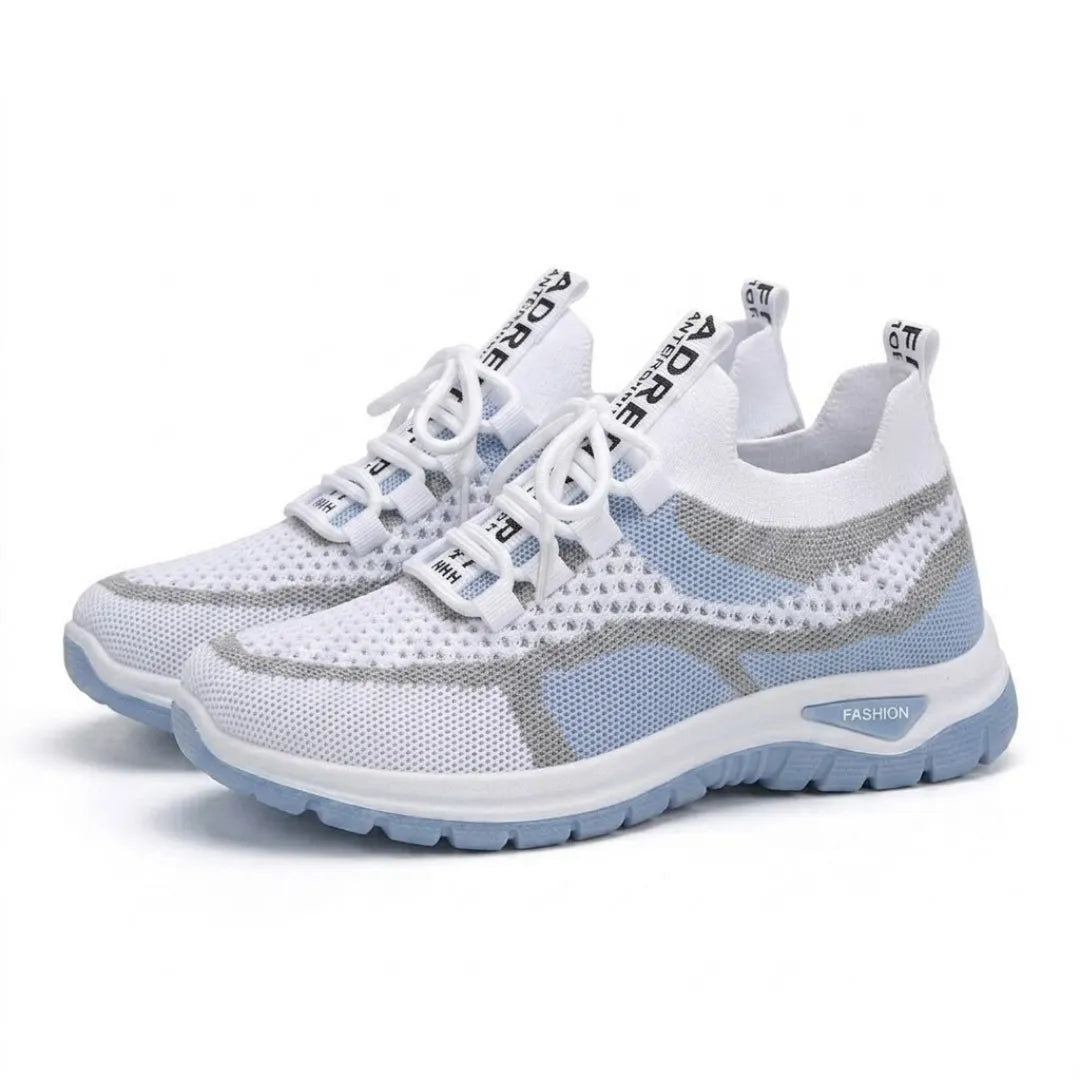 Pair of white and pale blue mesh trainers angled together on a plain white background, showing laces and sole. 7