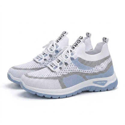 Pair of white and pale blue mesh trainers angled together on a plain white background, showing laces and sole. 7