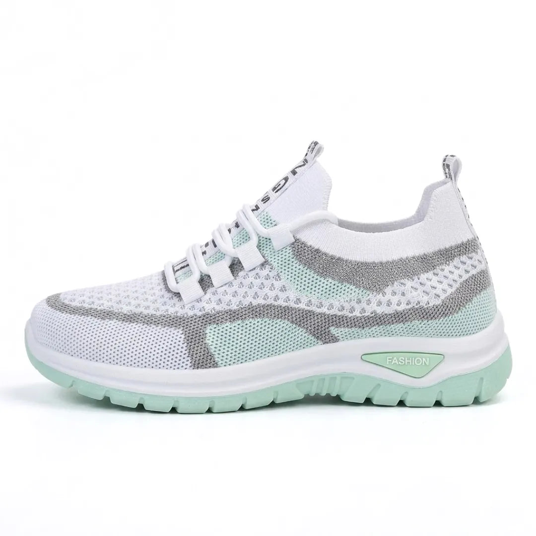 Side view of the white mesh trainer in mint green with grey stripes and a mint green chunky sole. 10