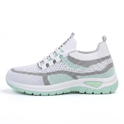 Side view of the white mesh trainer in mint green with grey stripes and a mint green chunky sole. 10