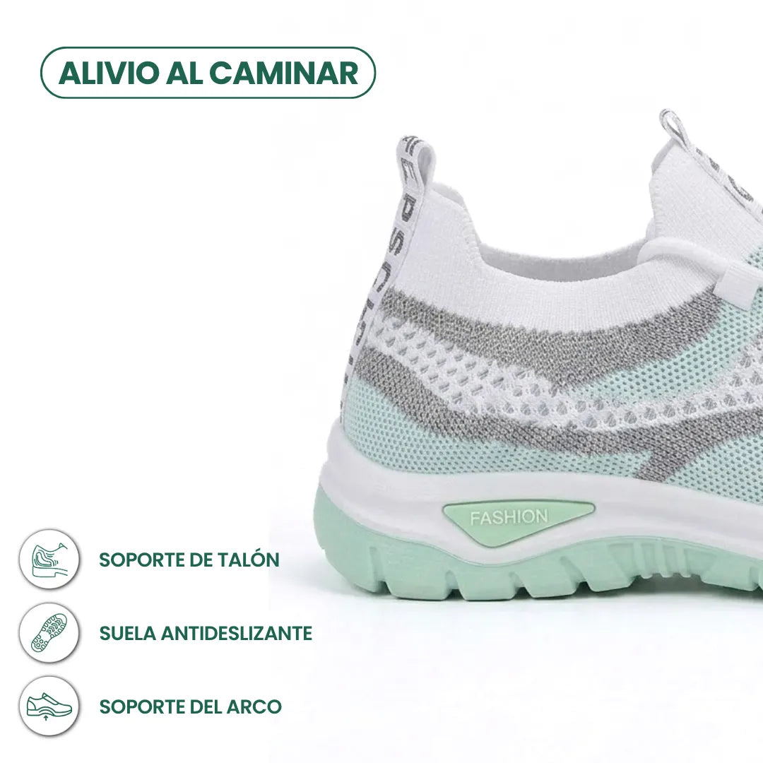 Rear three-quarter view of the mint green trainer showing the heel and sole, with icons for heel support and anti-slip sole. 13