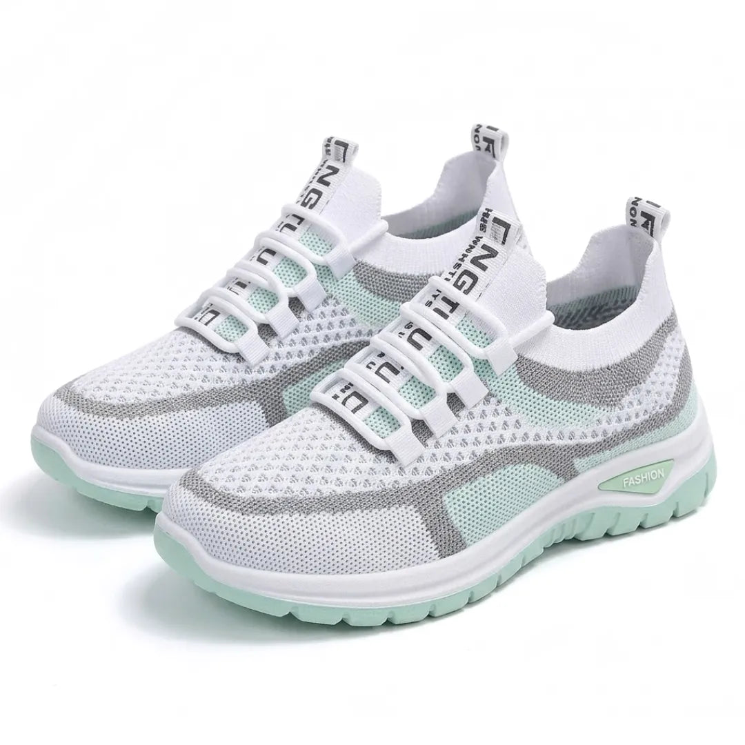 Pair of white and mint green mesh trainers with grey stripes angled together on a plain white background. 16