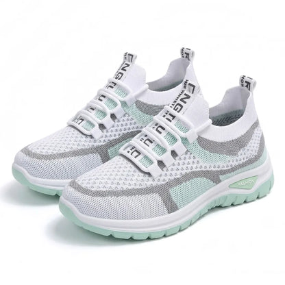 Pair of white and mint green mesh trainers with grey stripes angled together on a plain white background. 16