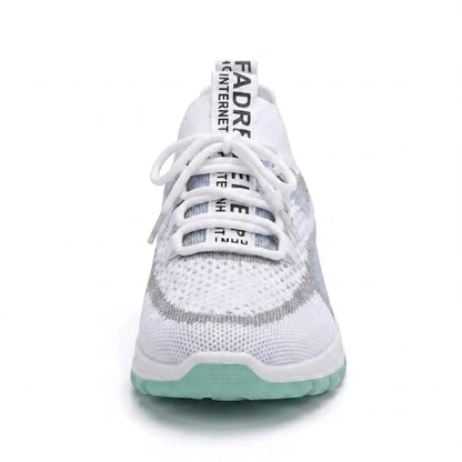 Front view of a white mesh trainer with a mint green sole, showing the laces, tongue tab and rounded toe. 17