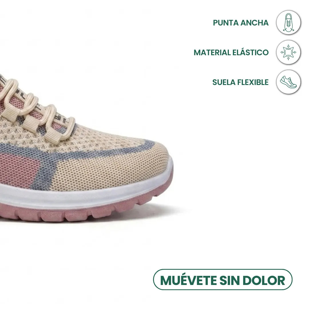 Close-up of the wide toe box of a beige, pink and grey mesh trainer, with comfort feature icons. 32