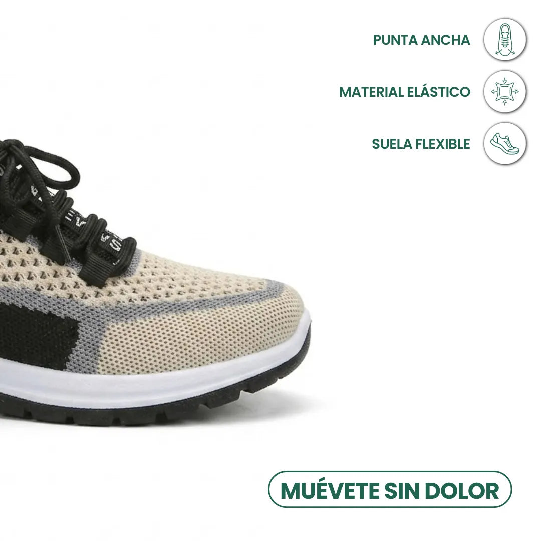 Close-up of the wide, rounded toe of the beige mesh trainer with black laces, grey trim and flexible white sole, with feature icons. 41