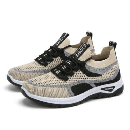 Pair of beige knitted mesh trainers with black and grey accents, black laces and white-and-black soles, shown from a three-quarter angle. 43