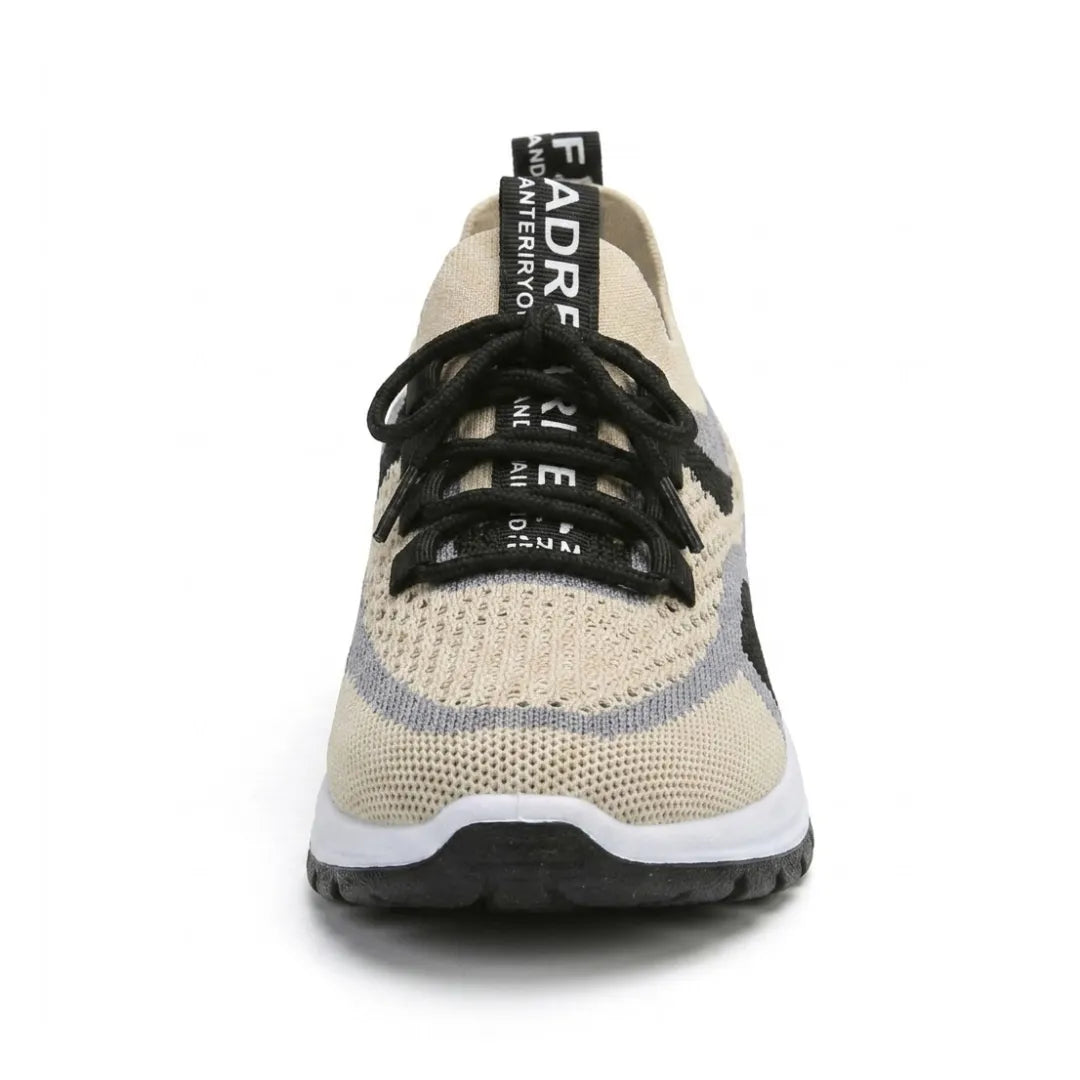 Front view of a beige breathable mesh trainer with black laces, grey and black side panels and a chunky white sole. 44