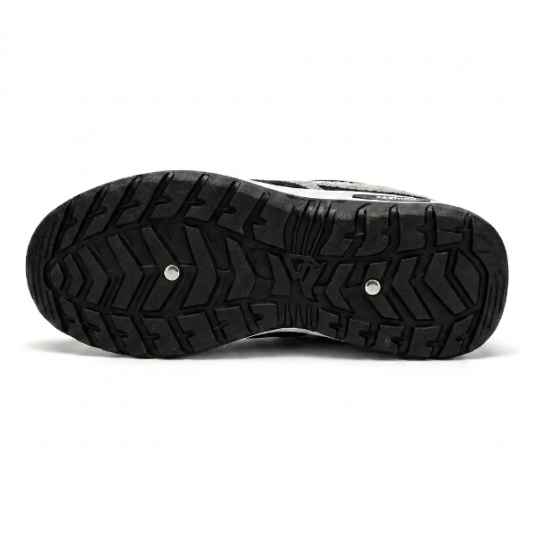 Underside of the trainer showing the black rubber outsole with deep chevron tread pattern and white midsole edge. 45