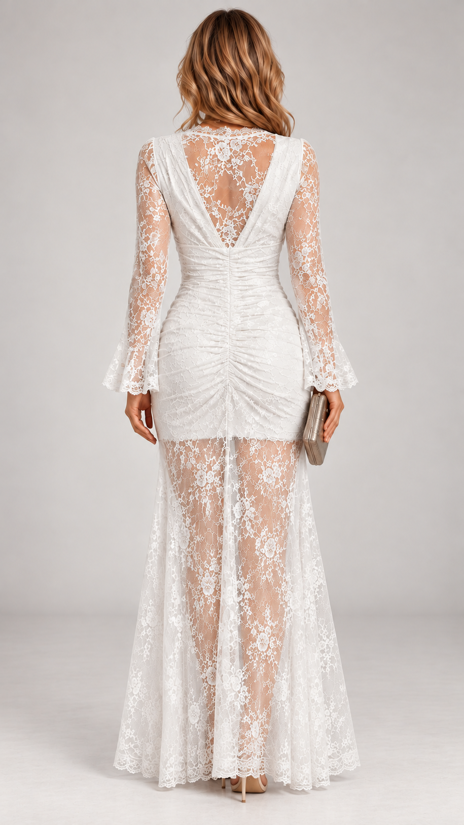 Back view of the white lace maxi dress, showing the open V-back, ruched centre seam and sheer lace skirt. 4