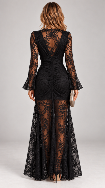 Back view of the black lace maxi dress, showing the open V-back, ruched centre seam and sheer flared lace skirt. 5