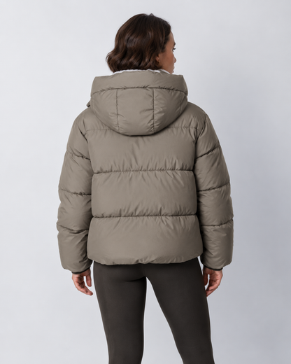 Back view of the taupe-grey puffer jacket with hood, showing the horizontal quilted panels 20